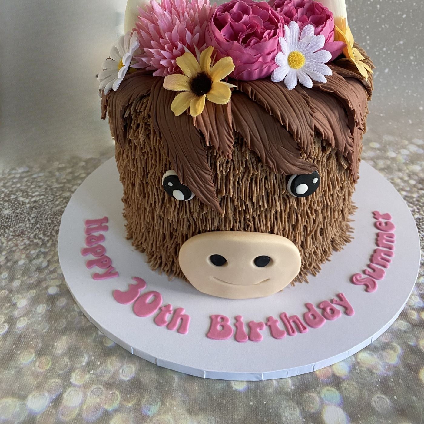 Highland cow 30th birthday cake with sugar flowers