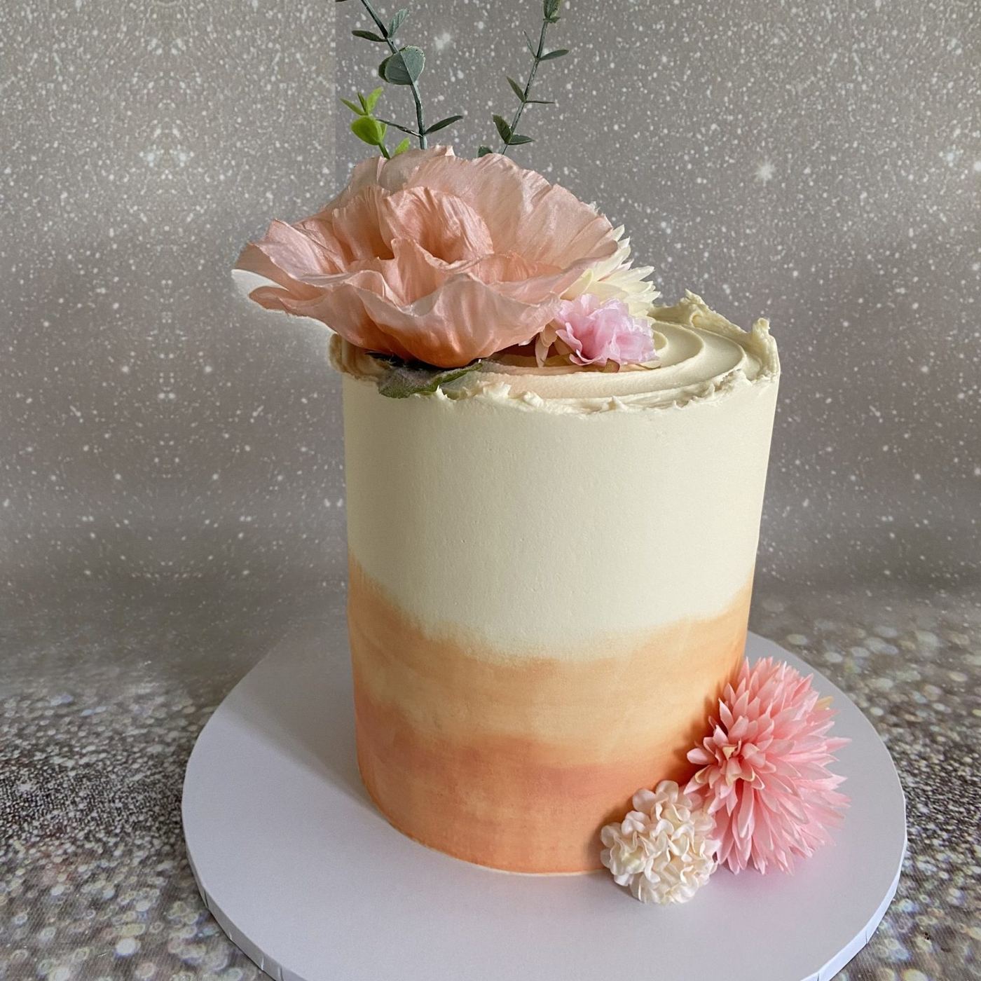 Peach ombre celebration cake with handmade sugar flowers